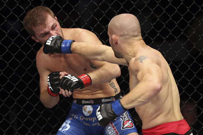 CALGARY, CANADA - JULY 21: (R-L) Mitch Gagnon lands a punch on Bryan Caraway during their bantamweight bout at UFC 149 inside the Scotiabank Saddledome on July 21, 2012 in Calgary, Alberta, Canada. (Photo by Nick Laham/Zuffa LLC/Zuffa LLC via Getty Imag