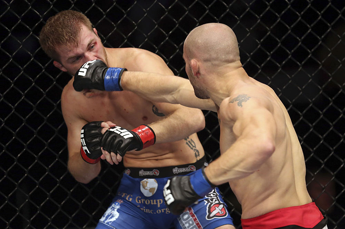 CALGARY, CANADA - JULY 21:  (R-L) Mitch Gagnon lands a punch on Bryan Caraway during their bantamweight bout at UFC 149 inside the Scotiabank Saddledome on July 21, 2012 in Calgary, Alberta, Canada.  (Photo by Nick Laham/Zuffa LLC/Zuffa LLC via Getty Imag