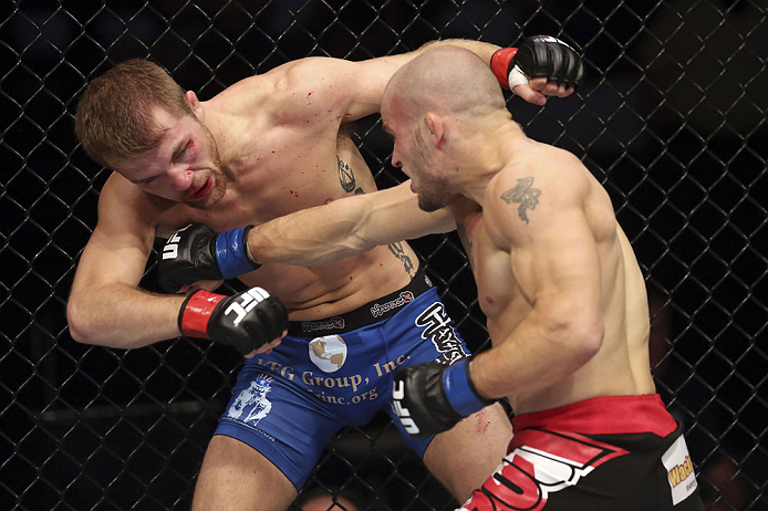 CALGARY, CANADA - JULY 21: (R-L) Mitch Gagnon lands a punch on Bryan Caraway during their bantamweight bout at UFC 149 inside the Scotiabank Saddledome on July 21, 2012 in Calgary, Alberta, Canada. (Photo by Nick Laham/Zuffa LLC/Zuffa LLC via Getty Image