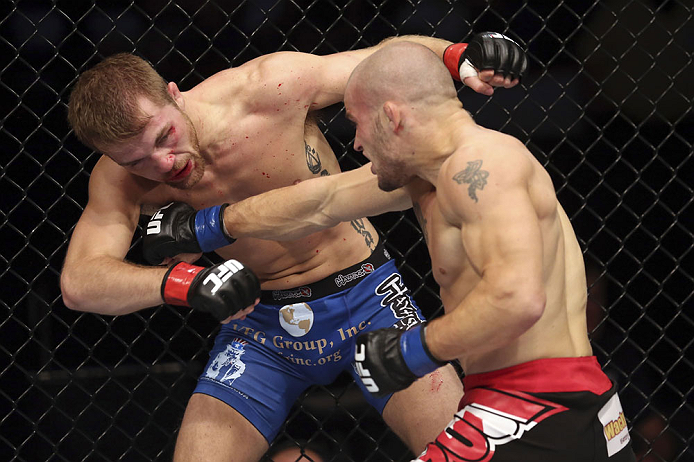 CALGARY, CANADA - JULY 21: (R-L) Mitch Gagnon lands a punch on Bryan Caraway during their bantamweight bout at UFC 149 inside the Scotiabank Saddledome on July 21, 2012 in Calgary, Alberta, Canada.  (Photo by Nick Laham/Zuffa LLC/Zuffa LLC via Getty Image