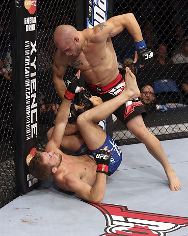 CALGARY, CANADA - JULY 21: (R-L) Mitch Gagnon stands over Bryan Caraway during their bantamweight bout at UFC 149 inside the Scotiabank Saddledome on July 21, 2012 in Calgary, Alberta, Canada. (Photo by Nick Laham/Zuffa LLC/Zuffa LLC via Getty Images)