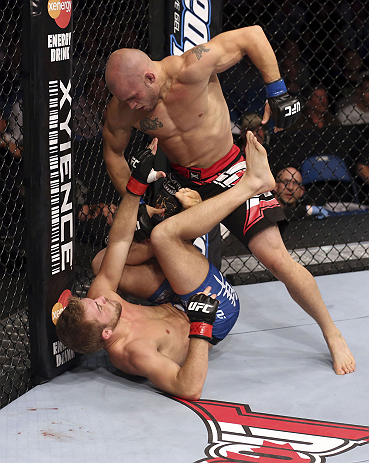 CALGARY, CANADA - JULY 21: (R-L) Mitch Gagnon stands over Bryan Caraway during their bantamweight bout at UFC 149 inside the Scotiabank Saddledome on July 21, 2012 in Calgary, Alberta, Canada.  (Photo by Nick Laham/Zuffa LLC/Zuffa LLC via Getty Images)