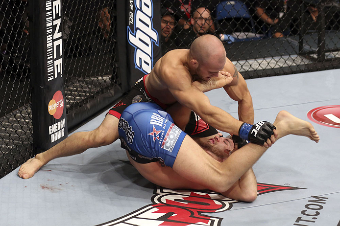 CALGARY, CANADA - JULY 21: (L-R) Mitch Gagnon powers over Bryan Caraway during their bantamweight bout at UFC 149 inside the Scotiabank Saddledome on July 21, 2012 in Calgary, Alberta, Canada. (Photo by Nick Laham/Zuffa LLC/Zuffa LLC via Getty Images)