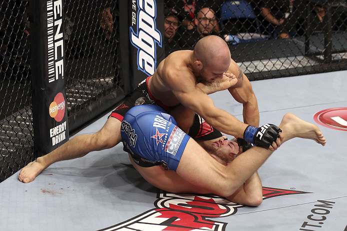 CALGARY, CANADA - JULY 21:  (L-R) Mitch Gagnon powers over Bryan Caraway during their bantamweight bout at UFC 149 inside the Scotiabank Saddledome on July 21, 2012 in Calgary, Alberta, Canada.  (Photo by Nick Laham/Zuffa LLC/Zuffa LLC via Getty Images)