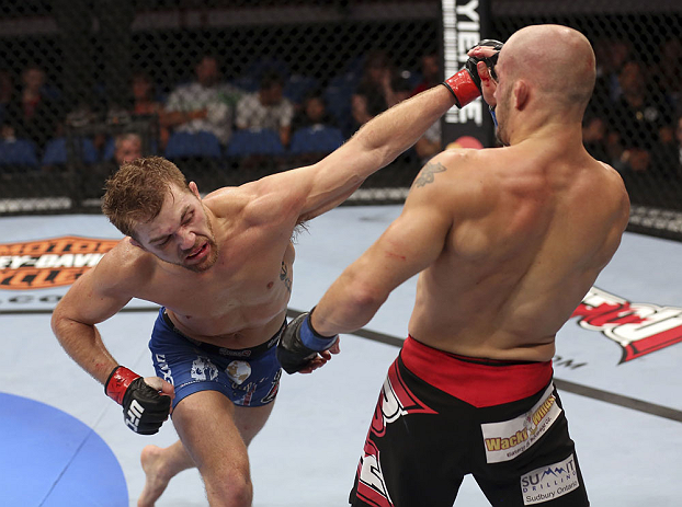 CALGARY, CANADA - JULY 21: (L-R) Bryan Caraway lands a punch on Mitch Gagnon during their bantamweight bout at UFC 149 inside the Scotiabank Saddledome on July 21, 2012 in Calgary, Alberta, Canada. (Photo by Nick Laham/Zuffa LLC/Zuffa LLC via Getty Image