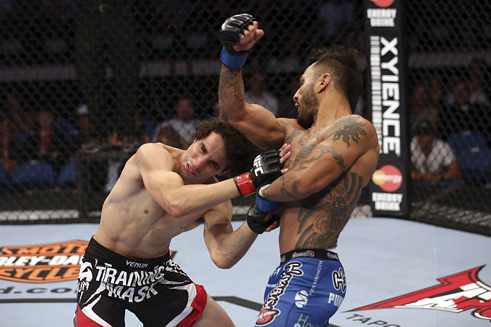 CALGARY, CANADA - JULY 21: (R-L) Francisco Rivera lands a punch to the head of Roland Delorme during their bantamweight bout at UFC 149 inside the Scotiabank Saddledome on July 21, 2012 in Calgary, Alberta, Canada. (Photo by Nick Laham/Zuffa LLC/Zuffa L