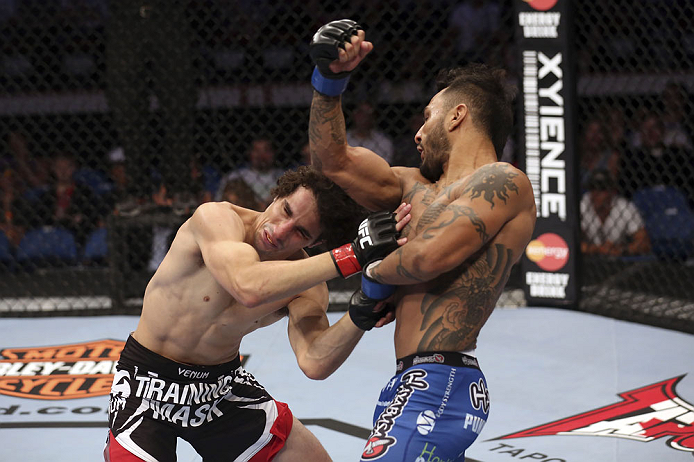 CALGARY, CANADA - JULY 21:  (R-L) Francisco Rivera lands a punch to the head of Roland Delorme during their bantamweight bout at UFC 149 inside the Scotiabank Saddledome on July 21, 2012 in Calgary, Alberta, Canada.  (Photo by Nick Laham/Zuffa LLC/Zuffa L