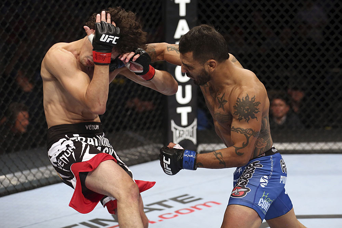 CALGARY, CANADA - JULY 21:  (R-L) Francisco Rivera lands a punch to the head of Roland Delorme during their bantamweight bout at UFC 149 inside the Scotiabank Saddledome on July 21, 2012 in Calgary, Alberta, Canada.  (Photo by Nick Laham/Zuffa LLC/Zuffa L