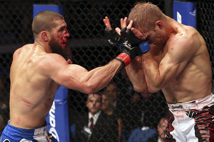 CALGARY, CANADA - JULY 21: (L-R) Court McGee throws a punch at Nick Ring during their middleweight bout at UFC 149 inside the Scotiabank Saddledome on July 21, 2012 in Calgary, Alberta, Canada.  (Photo by Nick Laham/Zuffa LLC/Zuffa LLC via Getty Images)