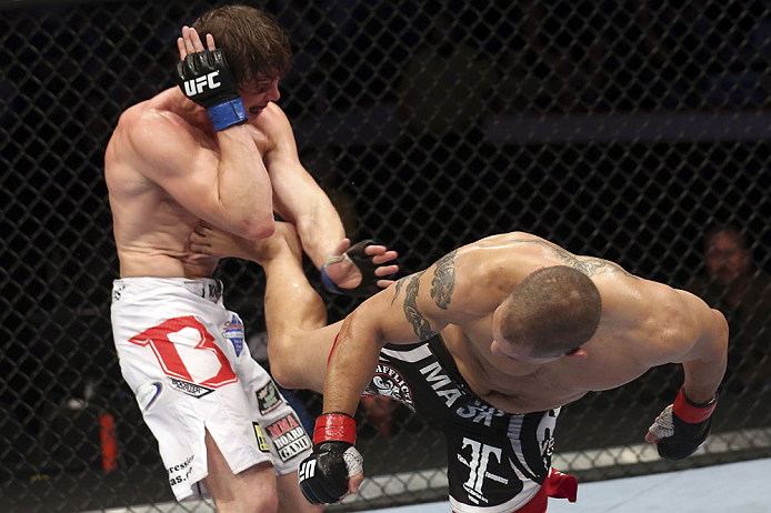 CALGARY, CANADA - JULY 21: (R-L) Chris Clements lands a kick to the ribs of Matthew Riddle during their welterweight bout at UFC 149 inside the Scotiabank Saddledome on July 21, 2012 in Calgary, Alberta, Canada. (Photo by Nick Laham/Zuffa LLC/Zuffa LLC v