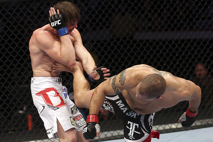 CALGARY, CANADA - JULY 21: (R-L) Chris Clements lands a kick to the ribs of Matthew Riddle during their welterweight bout at UFC 149 inside the Scotiabank Saddledome on July 21, 2012 in Calgary, Alberta, Canada.  (Photo by Nick Laham/Zuffa LLC/Zuffa LLC v