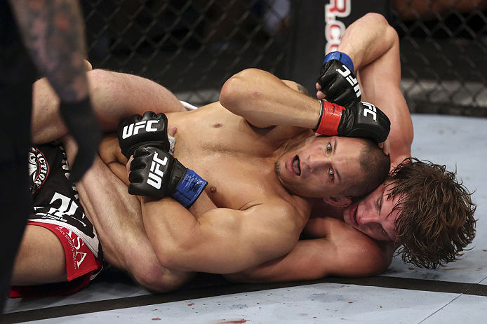 CALGARY, CANADA - JULY 21: Chris Clements is caught on his back by Matthew Riddle during their welterweight bout at UFC 149 inside the Scotiabank Saddledome on July 21, 2012 in Calgary, Alberta, Canada. (Photo by Nick Laham/Zuffa LLC/Zuffa LLC via Getty