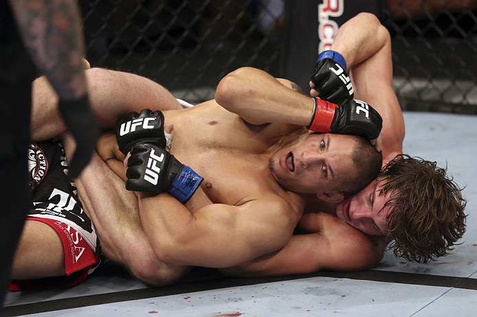 CALGARY, CANADA - JULY 21:  Chris Clements is caught on his back by Matthew Riddle during their welterweight bout at UFC 149 inside the Scotiabank Saddledome on July 21, 2012 in Calgary, Alberta, Canada.  (Photo by Nick Laham/Zuffa LLC/Zuffa LLC via Getty