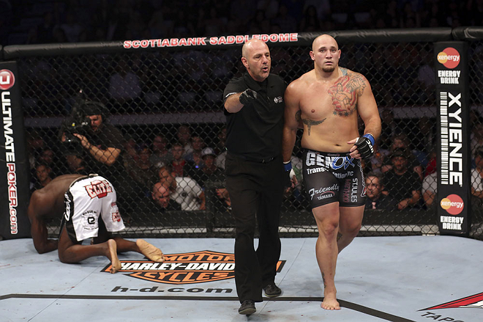 CALGARY, CANADA - JULY 21: (L-R) Cheick Kongo kneels after Shawn Jordan hit him with an accidental elbow below the belt during their heavyweight bout at UFC 149 inside the Scotiabank Saddledome on July 21, 2012 in Calgary, Alberta, Canada. (Photo by Nick