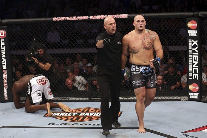 CALGARY, CANADA - JULY 21: (L-R) Cheick Kongo kneels after Shawn Jordan hit him with an accidental elbow below the belt during their heavyweight bout at UFC 149 inside the Scotiabank Saddledome on July 21, 2012 in Calgary, Alberta, Canada.  (Photo by Nick