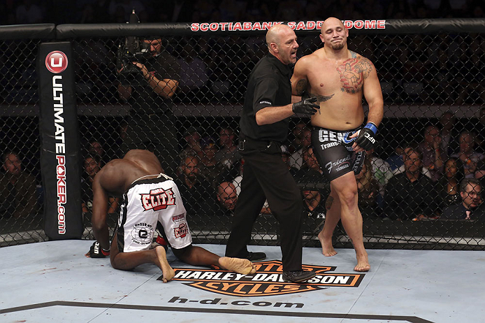 CALGARY, CANADA - JULY 21: (L-R) Cheick Kongo kneels after Shawn Jordan hit him with an accidental elbow below the belt during their heavyweight bout at UFC 149 inside the Scotiabank Saddledome on July 21, 2012 in Calgary, Alberta, Canada. (Photo by Nick