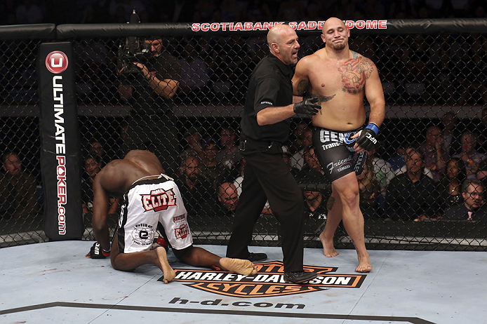 CALGARY, CANADA - JULY 21: (L-R) Cheick Kongo kneels after Shawn Jordan hit him with an accidental elbow below the belt during their heavyweight bout at UFC 149 inside the Scotiabank Saddledome on July 21, 2012 in Calgary, Alberta, Canada.  (Photo by Nick