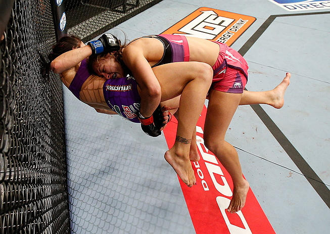 LAS VEGAS, NV - APRIL 13:   Miesha Tate (top) takes down Cat Zingano in their bantamweight fight at the Mandalay Bay Events Center  on April 13, 2013 in Las Vegas, Nevada.  (Photo by Josh Hedges/Zuffa LLC/Zuffa LLC via Getty Images)  *** Local Caption ***