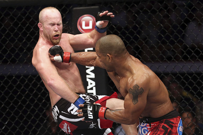 CALGARY, CANADA - JULY 21: (R-L) Hector Lombard lands a punch to the face of Tim Boetsch during their middleweight bout at UFC 149 inside the Scotiabank Saddledome on July 21, 2012 in Calgary, Alberta, Canada. (Photo by Nick Laham/Zuffa LLC/Zuffa LLC via