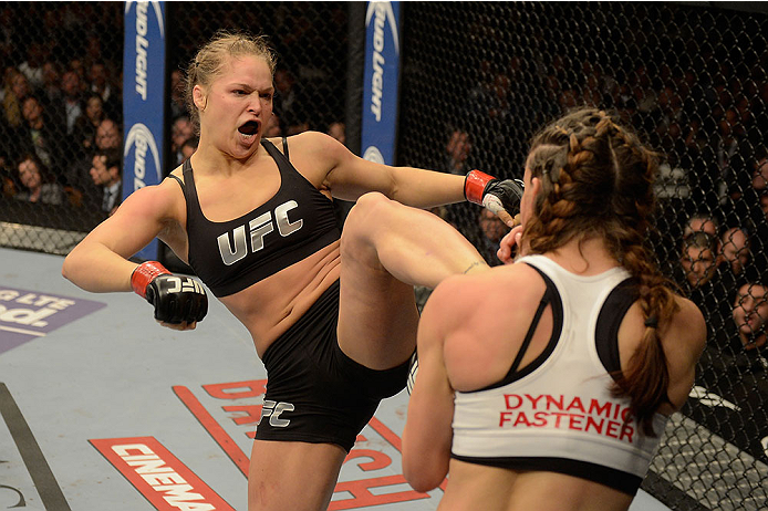 LAS VEGAS, NV - DECEMBER 28:  (L-R) Ronda Rousey kicks Miesha Tate in their UFC women's bantamweight championship bout during the UFC 168 event at the MGM Grand Garden Arena on December 28, 2013 in Las Vegas, Nevada. (Photo by Donald Miralle/Zuffa LLC/Zuf