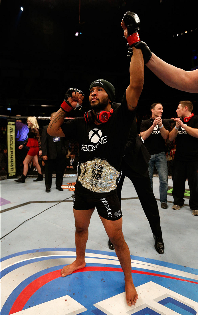 SACRAMENTO, CA - DECEMBER 14: Demetrious Johnson has the flyweight championship belt placed around his waist during the UFC on FOX event at Sleep Train Arena on December 14, 2013 in Sacramento, California. (Photo by Josh Hedges/Zuffa LLC/Zuffa LLC via Ge
