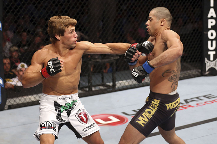 CALGARY, CANADA - JULY 21: (L-R) Urijah Faber throws a punch at Renan Barao during their UFC interim bantamweight championship bout at UFC 149 inside the Scotiabank Saddledome on July 21, 2012 in Calgary, Alberta, Canada. (Photo by Nick Laham/Zuffa LLC/Z