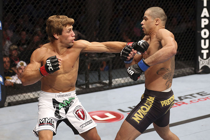 CALGARY, CANADA - JULY 21: (L-R) Urijah Faber throws a punch at Renan Barao during their UFC interim bantamweight championship bout at UFC 149 inside the Scotiabank Saddledome on July 21, 2012 in Calgary, Alberta, Canada.  (Photo by Nick Laham/Zuffa LLC/Z