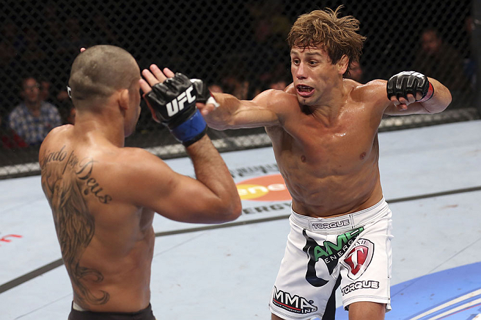 CALGARY, CANADA - JULY 21: (R-L) Urijah Faber throws a punch at Renan Barao during their UFC interim bantamweight championship bout at UFC 149 inside the Scotiabank Saddledome on July 21, 2012 in Calgary, Alberta, Canada. (Photo by Nick Laham/Zuffa LLC/Z