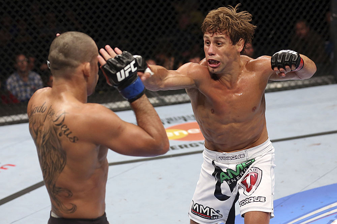 CALGARY, CANADA - JULY 21: (R-L) Urijah Faber throws a punch at Renan Barao during their UFC interim bantamweight championship bout at UFC 149 inside the Scotiabank Saddledome on July 21, 2012 in Calgary, Alberta, Canada.  (Photo by Nick Laham/Zuffa LLC/Z