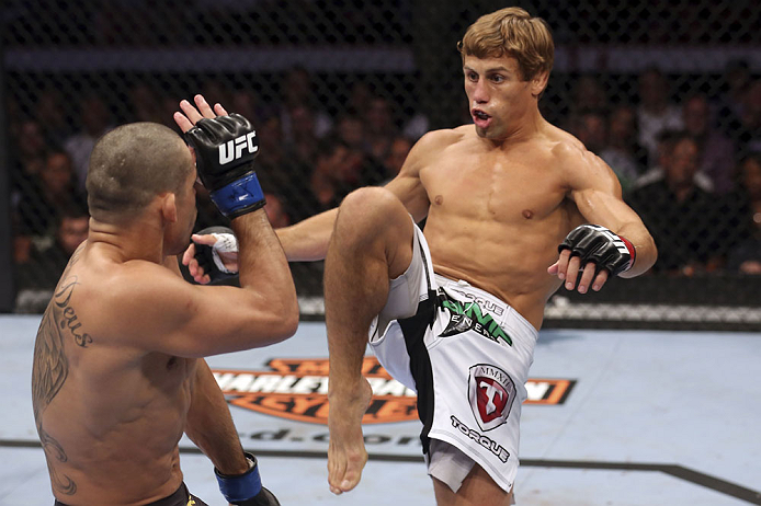 CALGARY, CANADA - JULY 21: (R-L) Urijah Faber attempts a kick to the body of Renan Barao during their UFC interim bantamweight championship bout at UFC 149 inside the Scotiabank Saddledome on July 21, 2012 in Calgary, Alberta, Canada. (Photo by Nick Laha