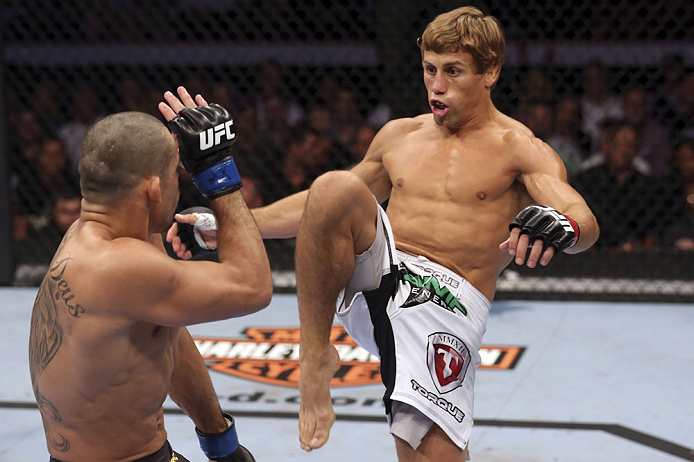 CALGARY, CANADA - JULY 21: (R-L) Urijah Faber attempts a kick to the body of Renan Barao during their UFC interim bantamweight championship bout at UFC 149 inside the Scotiabank Saddledome on July 21, 2012 in Calgary, Alberta, Canada.  (Photo by Nick Laha