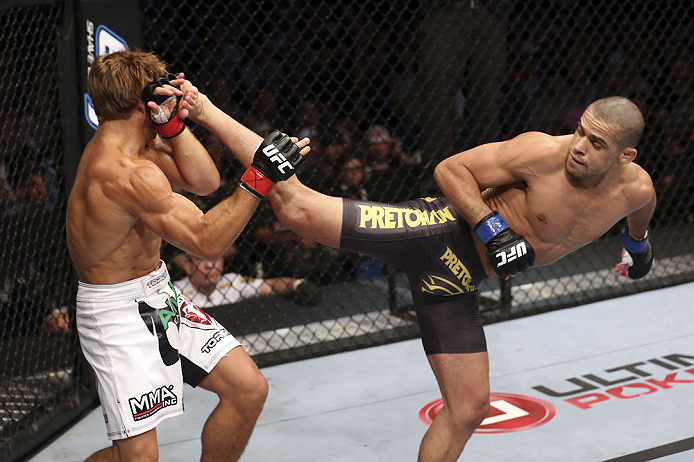 CALGARY, CANADA - JULY 21: (L-R) Urijah Faber blocks a kick from Renan Barao during their UFC interim bantamweight championship bout at UFC 149 inside the Scotiabank Saddledome on July 21, 2012 in Calgary, Alberta, Canada.  (Photo by Nick Laham/Zuffa LLC/