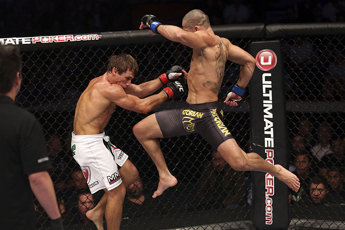 CALGARY, CANADA - JULY 21: (R-L) Renan Barao leaps toward Urijah Faber during their UFC interim bantamweight championship bout at UFC 149 inside the Scotiabank Saddledome on July 21, 2012 in Calgary, Alberta, Canada.  (Photo by Nick Laham/Zuffa LLC/Zuffa 