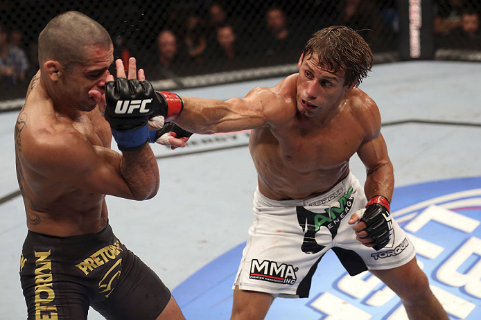 CALGARY, CANADA - JULY 21: (R-L) Urijah Faber throws a punch at Renan Barao during their UFC interim bantamweight championship bout at UFC 149 inside the Scotiabank Saddledome on July 21, 2012 in Calgary, Alberta, Canada.  (Photo by Nick Laham/Zuffa LLC/Z