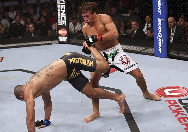 CALGARY, CANADA - JULY 21: (R-L) Urijah Faber counters a kick from Renan Barao during their UFC interim bantamweight championship bout at UFC 149 inside the Scotiabank Saddledome on July 21, 2012 in Calgary, Alberta, Canada. (Photo by Nick Laham/Zuffa LL