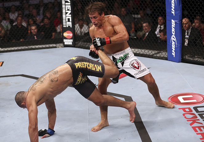 CALGARY, CANADA - JULY 21: (R-L) Urijah Faber counters a kick from Renan Barao during their UFC interim bantamweight championship bout at UFC 149 inside the Scotiabank Saddledome on July 21, 2012 in Calgary, Alberta, Canada.  (Photo by Nick Laham/Zuffa LL