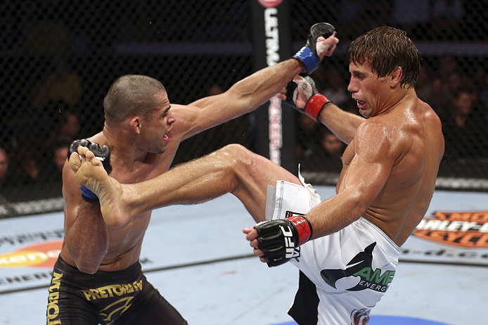 CALGARY, CANADA - JULY 21: (L-R) Renan Barao blocks a kick from Urijah Faber during their UFC interim bantamweight championship bout at UFC 149 inside the Scotiabank Saddledome on July 21, 2012 in Calgary, Alberta, Canada.  (Photo by Nick Laham/Zuffa LLC/