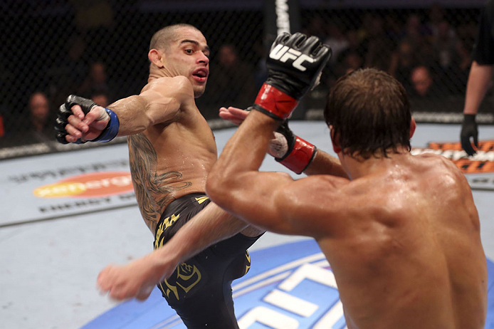 CALGARY, CANADA - JULY 21: (L-R) Renan Barao attempts a kick at Urijah Faber during their UFC interim bantamweight championship bout at UFC 149 inside the Scotiabank Saddledome on July 21, 2012 in Calgary, Alberta, Canada. (Photo by Nick Laham/Zuffa LLC/