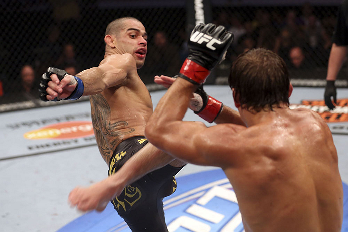 CALGARY, CANADA - JULY 21: (L-R) Renan Barao attempts a kick at Urijah Faber during their UFC interim bantamweight championship bout at UFC 149 inside the Scotiabank Saddledome on July 21, 2012 in Calgary, Alberta, Canada.  (Photo by Nick Laham/Zuffa LLC/