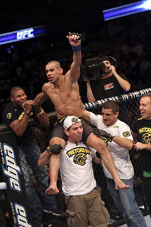 CALGARY, CANADA - JULY 21:  Renan Barao celebrates with his team after his victory over Urijah Faber after their UFC interim bantamweight championship bout at UFC 149 inside the Scotiabank Saddledome on July 21, 2012 in Calgary, Alberta, Canada.  (Photo b