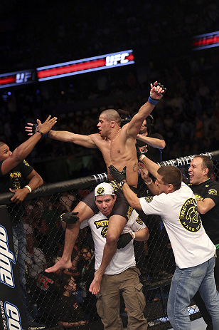 CALGARY, CANADA - JULY 21: Renan Barao celebrates with his team after his victory over Urijah Faber after their UFC interim bantamweight championship bout at UFC 149 inside the Scotiabank Saddledome on July 21, 2012 in Calgary, Alberta, Canada. (Photo b
