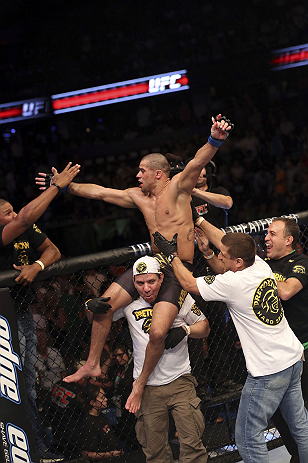 CALGARY, CANADA - JULY 21:  Renan Barao celebrates with his team after his victory over Urijah Faber after their UFC interim bantamweight championship bout at UFC 149 inside the Scotiabank Saddledome on July 21, 2012 in Calgary, Alberta, Canada.  (Photo b