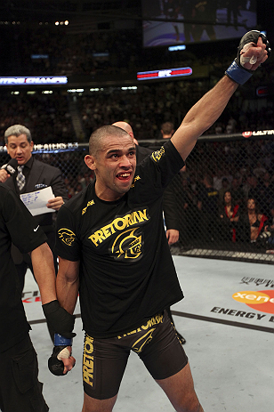 CALGARY, CANADA - JULY 21: Renan Barao celebrates his victory over Urijah Faber during their UFC interim bantamweight championship bout at UFC 149 inside the Scotiabank Saddledome on July 21, 2012 in Calgary, Alberta, Canada. (Photo by Nick Laham/Zuffa
