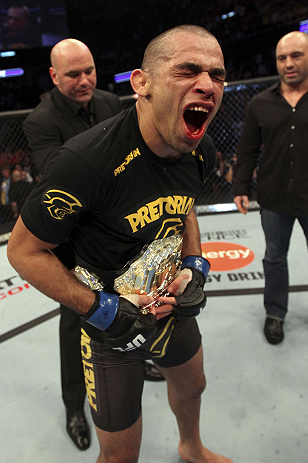 CALGARY, CANADA - JULY 21:  Renan Barao celebrates his victory over Urijah Faber as UFC President Dana White gives him the Championship belt after their UFC interim bantamweight championship bout at UFC 149 inside the Scotiabank Saddledome on July 21, 201