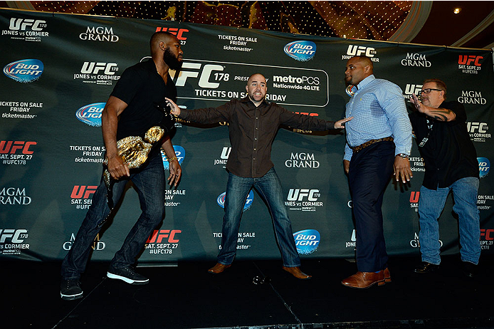 LAS VEGAS, NV - AUG 4: (L-R) UFC light heavyweight champion Jon Jones and challenger Daniel Cormier are separated after facing off during the UFC 178 Ultimate Media Day at the MGM Grand Hotel/Casino on August 4, 2014 in Las Vegas, Nevada. (Photo by Jeff