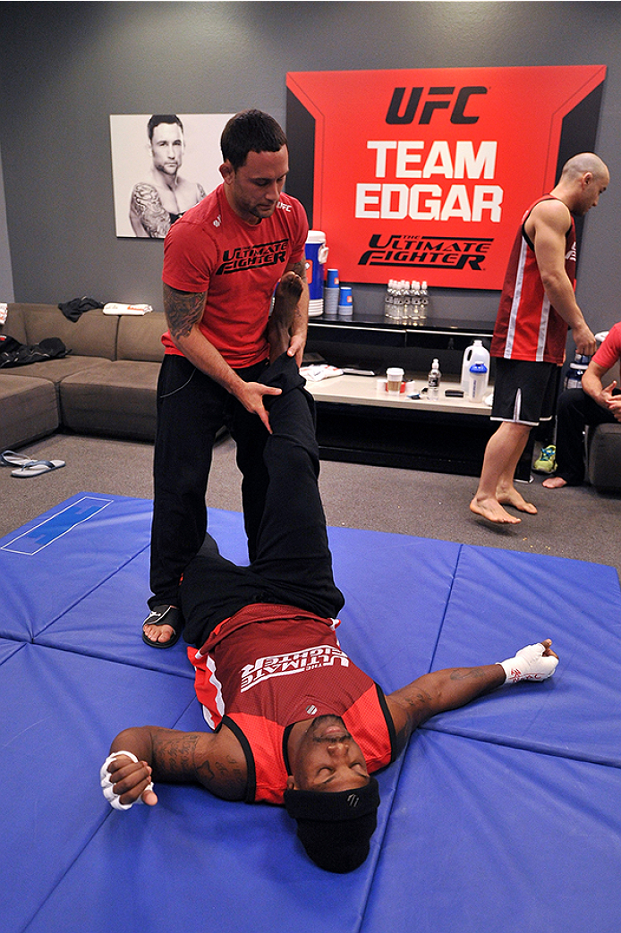 LAS VEGAS, NV - OCTOBER 29: (L-R) Coach Frankie Edgar stretches his fighter Todd Monaghan before he faces Team Penn fighter Daniel Spohn in their preliminary fight during filming of season nineteen of The Ultimate Fighter on October 29, 2013 in Las Vegas