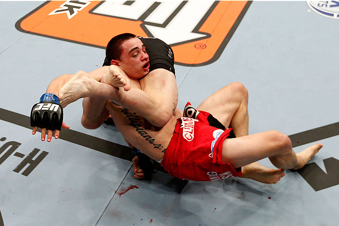 LAS VEGAS, NV - NOVEMBER 30:  Ryan Benoit (red shorts) gets flipped by Josh Sampo in their flyweight fight during The Ultimate Fighter season 18 live finale inside the Mandalay Bay Events Center on November 30, 2013 in Las Vegas, Nevada. (Photo by Josh He