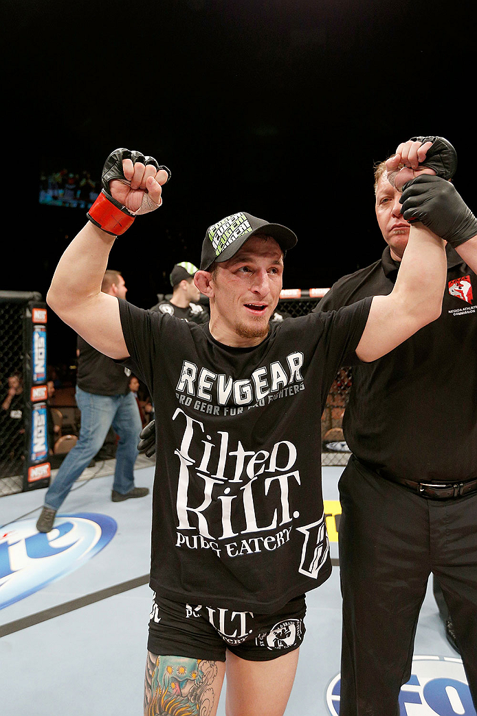LAS VEGAS, NV - NOVEMBER 30: Josh Sampo celebrates after submitting Ryan Benoit by rear naked choke in their flyweight fight during The Ultimate Fighter season 18 live finale inside the Mandalay Bay Events Center on November 30, 2013 in Las Vegas, Nevada