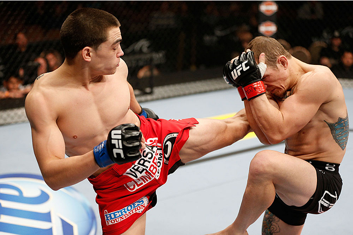 LAS VEGAS, NV - NOVEMBER 30: (L-R) Ryan Benoit kicks Josh Sampo in their flyweight fight during The Ultimate Fighter season 18 live finale inside the Mandalay Bay Events Center on November 30, 2013 in Las Vegas, Nevada. (Photo by Josh Hedges/Zuffa LLC/Zu