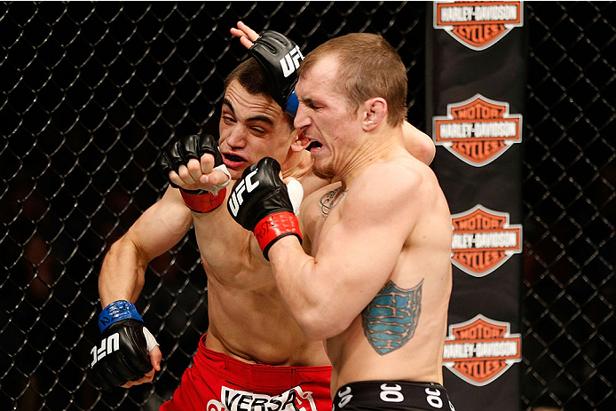 LAS VEGAS, NV - NOVEMBER 30:  (R-L) Josh Sampo punches Ryan Benoit in their flyweight fight during The Ultimate Fighter season 18 live finale inside the Mandalay Bay Events Center on November 30, 2013 in Las Vegas, Nevada. (Photo by Josh Hedges/Zuffa LLC/